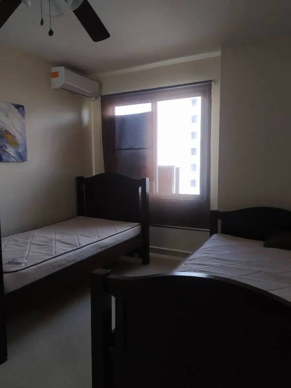 Living room with large windows, AC and ceiling fan at PH Del Rey El Cangrejo