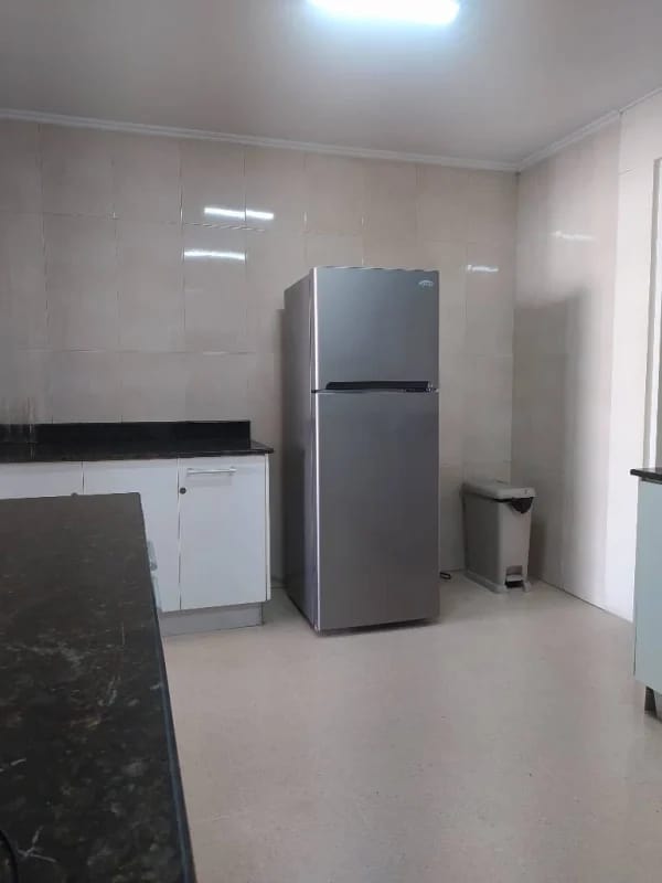 Kitchen with granite countertops stainless steel fridge and white cabinets at PH Del Rey El Cangrejo Panama
