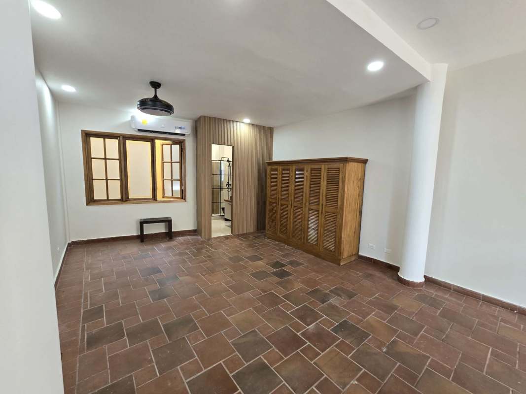 Yellow colonial building with balconies, arches and storefront Casco Viejo historic Panama