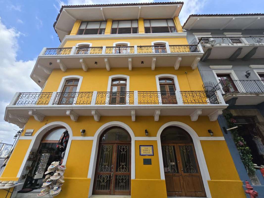 Three-story colonial yellow building with balconies and decorative moldings Casco Viejo Panama