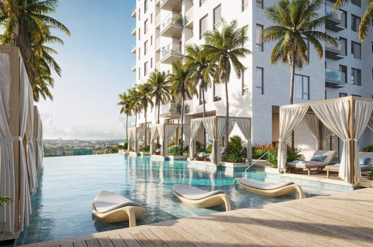 Infinity pool, palm trees, balconies of PH Corotú luxury apartments in Santa María