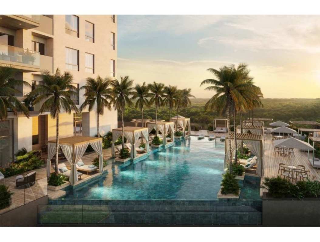 Infinity pool with sun loungers, palm trees, cabins at PH Corotú Santa María