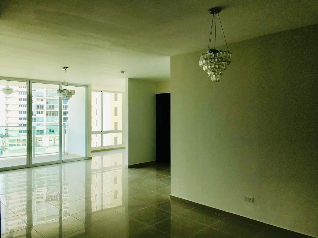 Spacious modern kitchen with granite countertops, wood cabinetry, island and stainless steel appliances in PH Ocean Drive Punta Pacífica