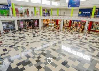 Shopping mall atrium with storefronts colorful columns Westland Mall Panama Vista Alegre