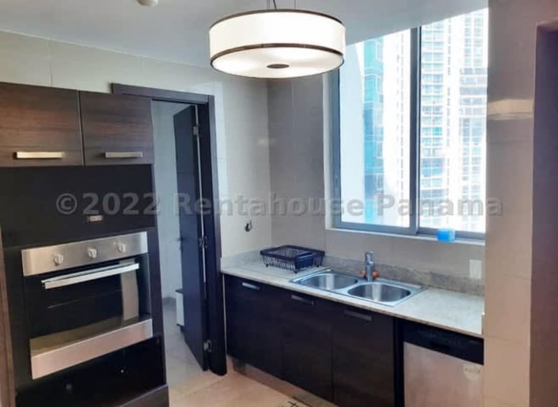 Contemporary kitchen with granite countertops, dark cabinets, stainless appliances in Grand Tower Punta Pacifica