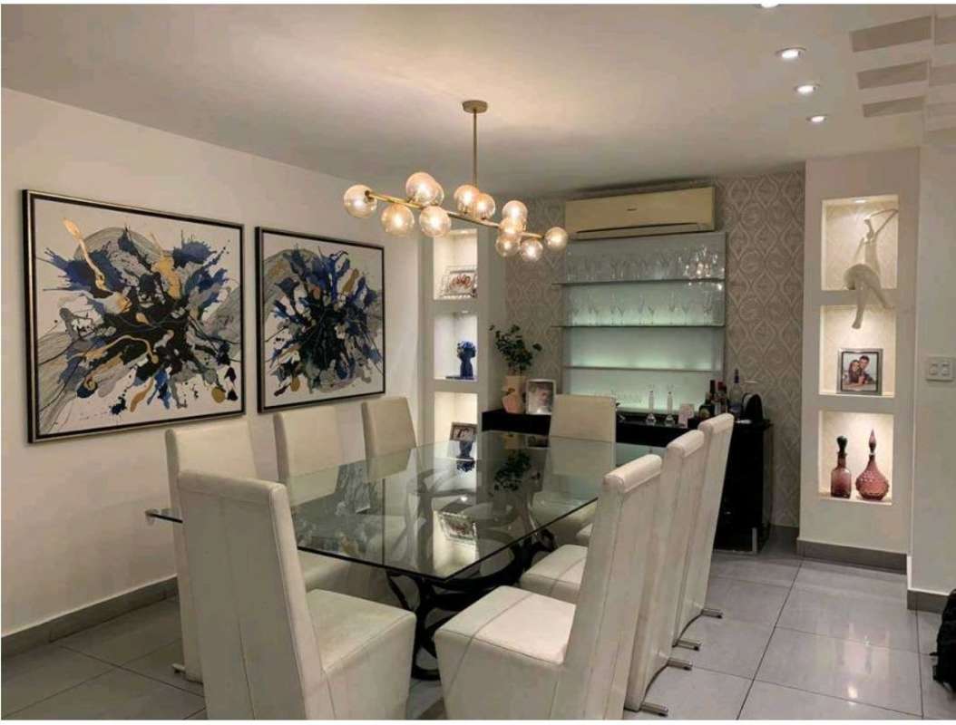 Large dining room with chandelier, art, bar area in PH Mystic Point