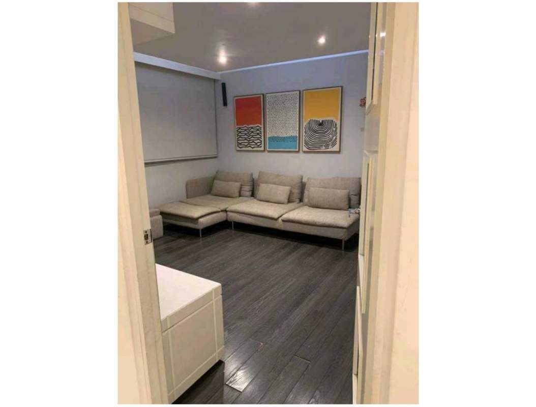 Living room with sectional sofa and projection screen at PH Mystic Point