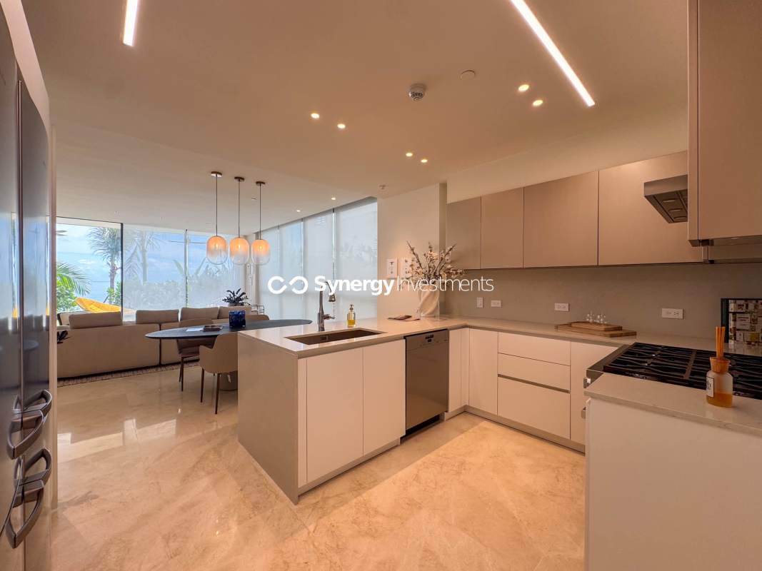 Bright living area with floor-to-ceiling windows terrace access ocean view Punta Pacífica Panama