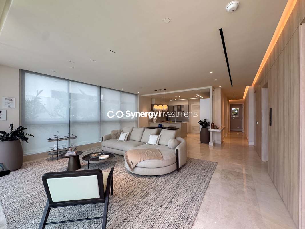 Elegant bathroom with marble tiles, double sinks, glass shower Ocean Reef Islands Punta Pacifica Panama