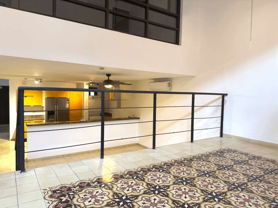 Modern loft design mezzanine overlooking kitchen with natural light Casa Ruigar Casco Viejo Panama