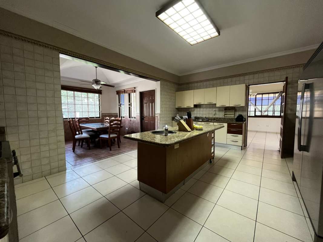 Rustic-style covered BBQ outdoor kitchen with bar and ceiling fans Clayton Camino de Cruces Panama