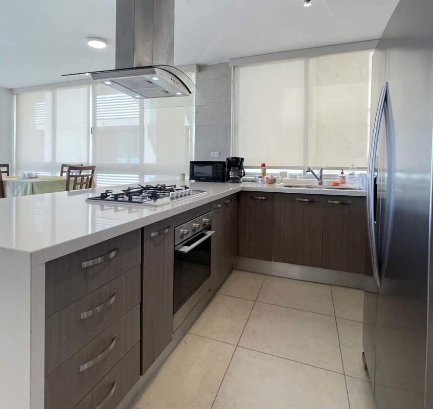 Large open kitchen with island and stainless steel appliances PH Costa View Tower Costa del Este Panama