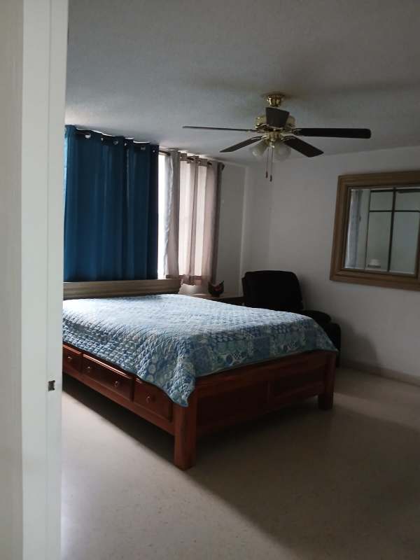 Bedroom in PH El Dorado Park Tower with closet, window, AC, single bed, armchair Panama City