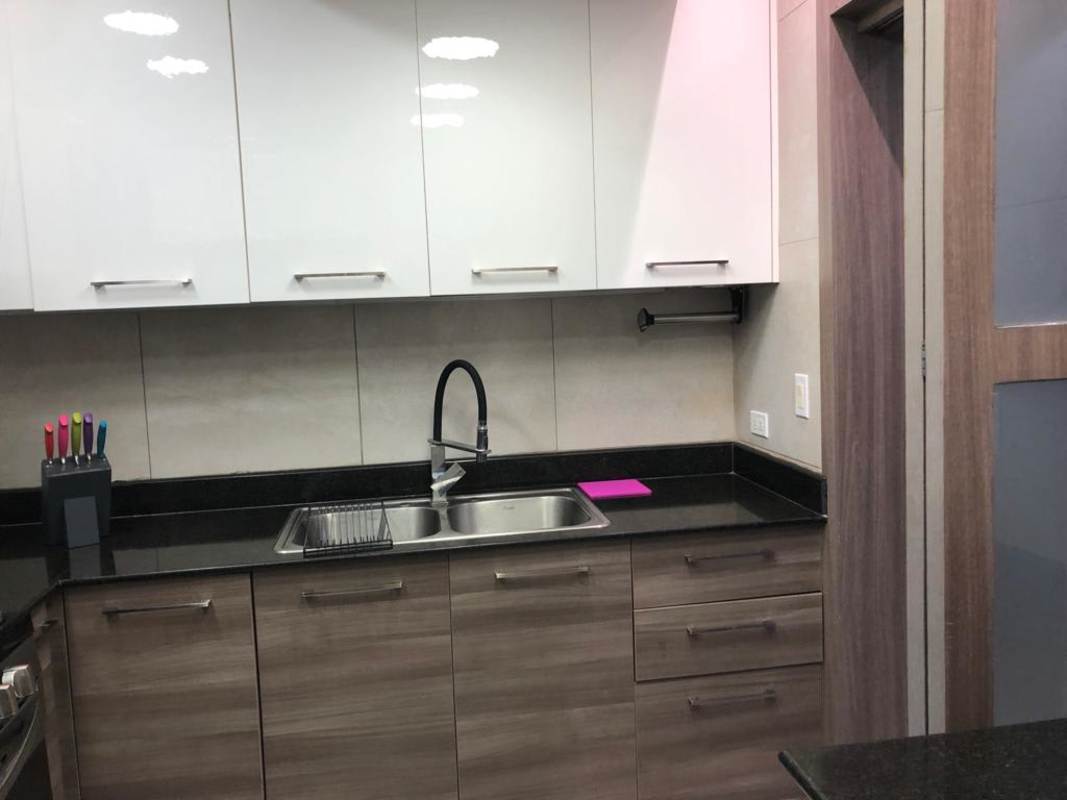 Modern kitchen with appliances, granite counters, and wood cabinets in PH Pacific Hills Elite 500