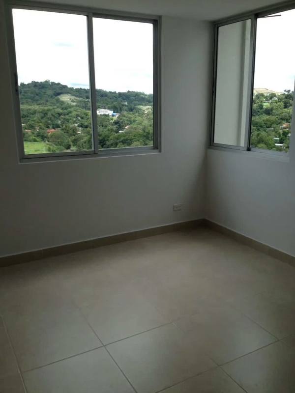 Minimalist bedroom with built-in wardrobe and large window in Villa Zaita Panama