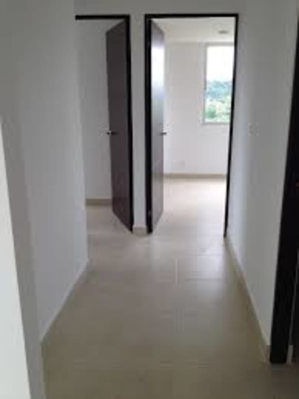 Bedroom with large windows and built-in wooden wardrobe at PH Vista del Rocío Panama