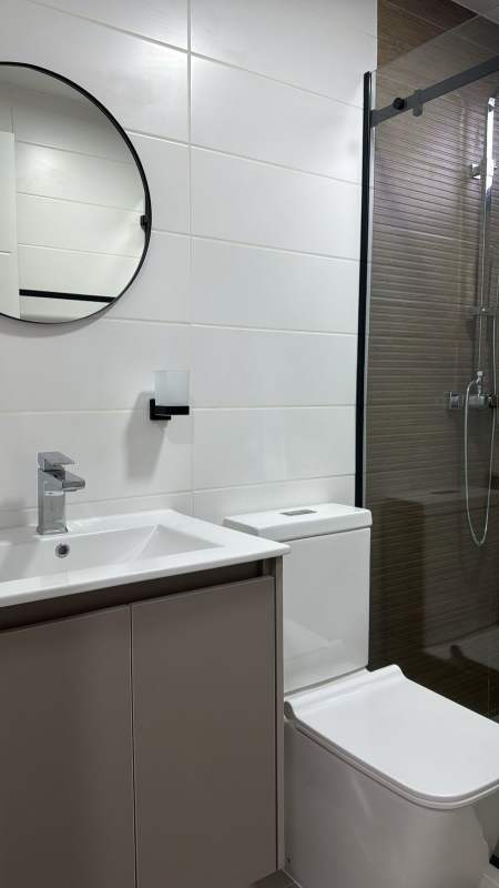 Contemporary bathroom with shower cabin and sink in PH Sky 66 San Francisco Panama apartment