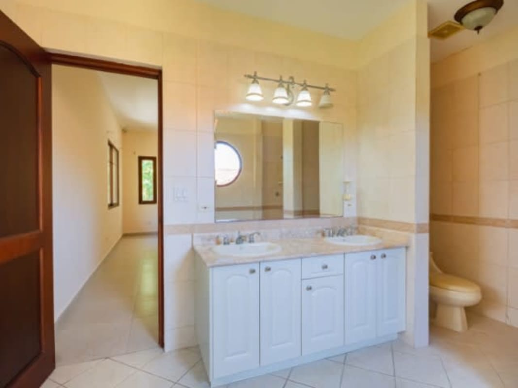 Remodeled kitchen with granite countertops, island, wood cabinetry and bay window in luxury house Clayton Panama