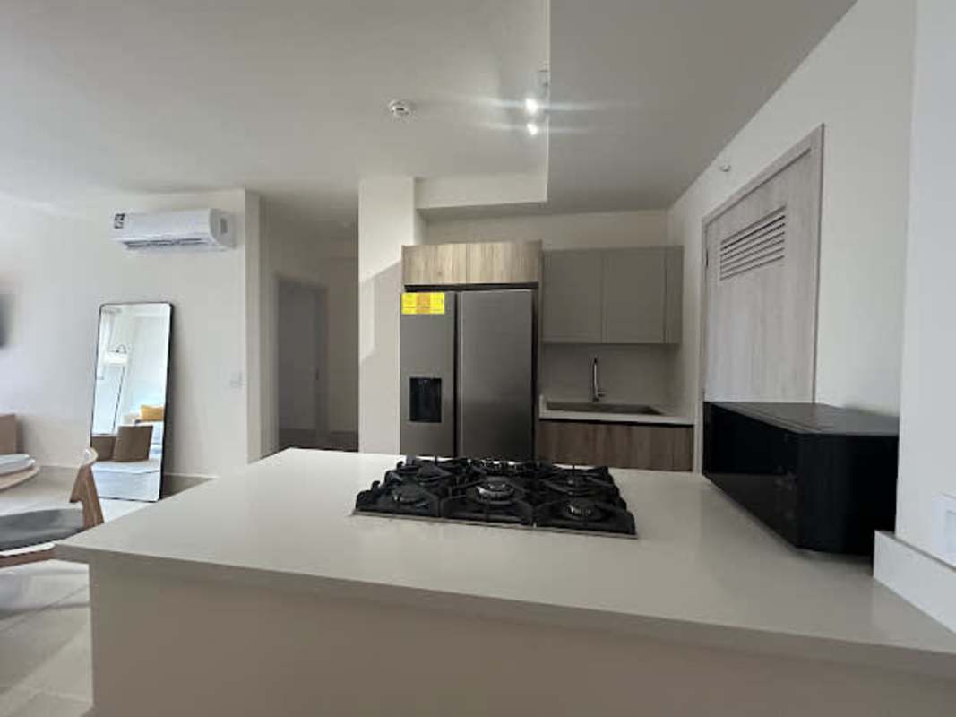 Spacious master bedroom offering golf course views through panoramic windows in Santa Maria Panama condo