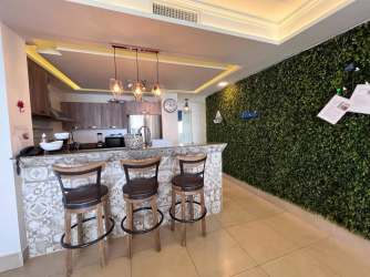 Open kitchen with granite counters and breakfast bar in beachfront PH Rio Mar condo Coronado Panama