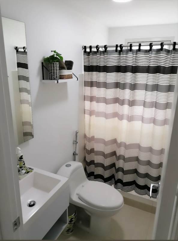 Modern bathroom with vanity, mirror, and shower in PH Panamá Viejo Residences rental apartment Panama City