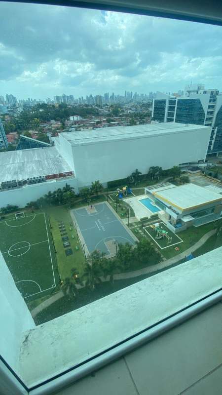 Swimming pool, children's playground, and sports courts at PH Kings Park Condado del Rey Panama