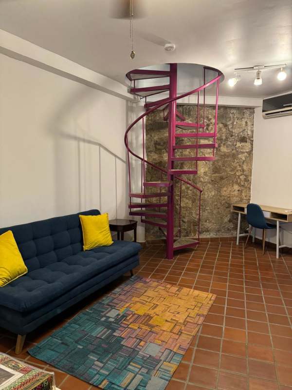 Cozy living room with leather sofa french doors abstract art Casco Viejo Panama