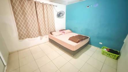 Bedroom with blue accent wall tile floors affordable family house Residencial Corotú Panama West