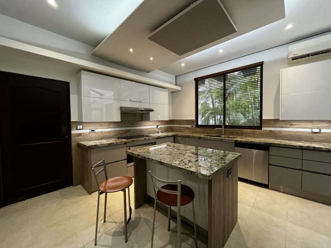 Remodeled kitchen with granite countertops, center island, stainless appliances in Clayton Panama