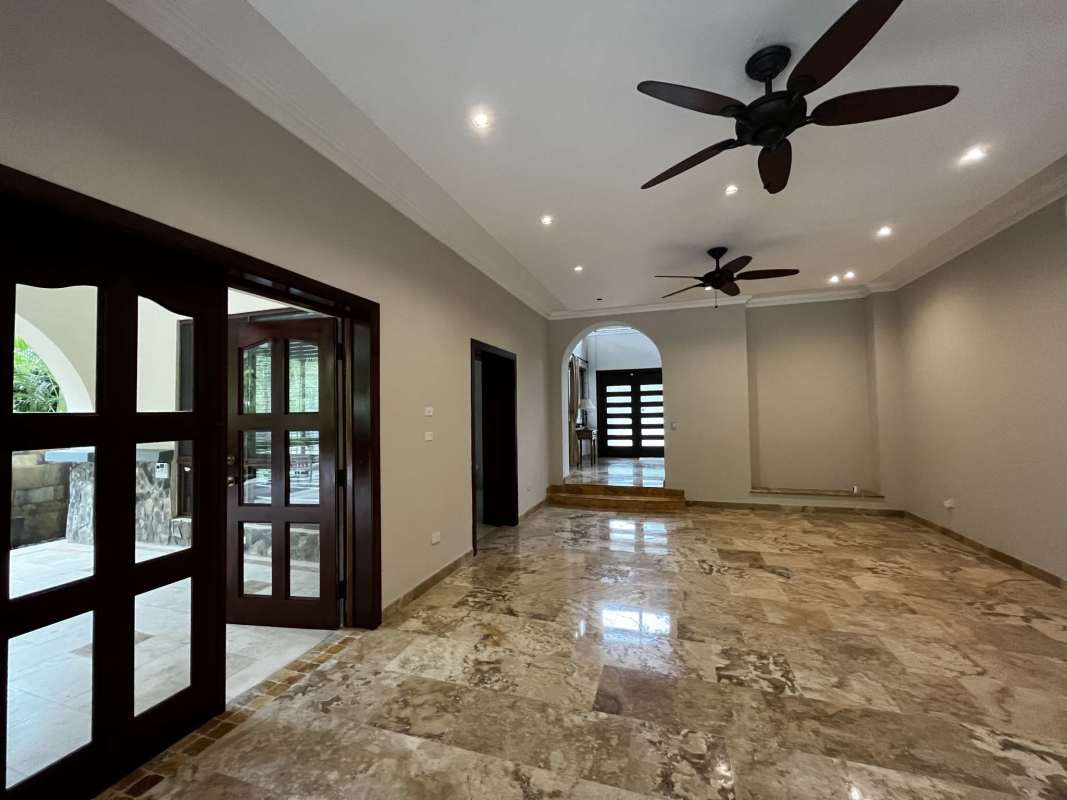 Living room with marble flooring, large windows and ceiling fans in Clayton Camino de Cruces house for rent