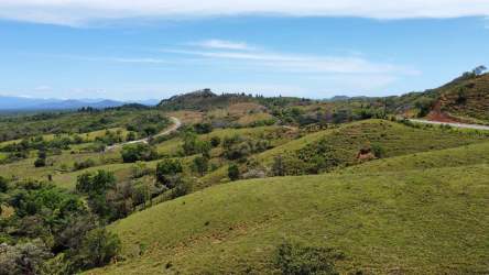 Hilly countryside with road access lush vegetation and ocean views near Boca Chica Panama