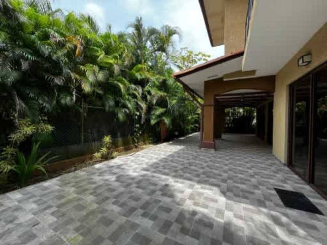 Tiled spacious patio and landscaped greenery in luxury house Embassy Club Panama
