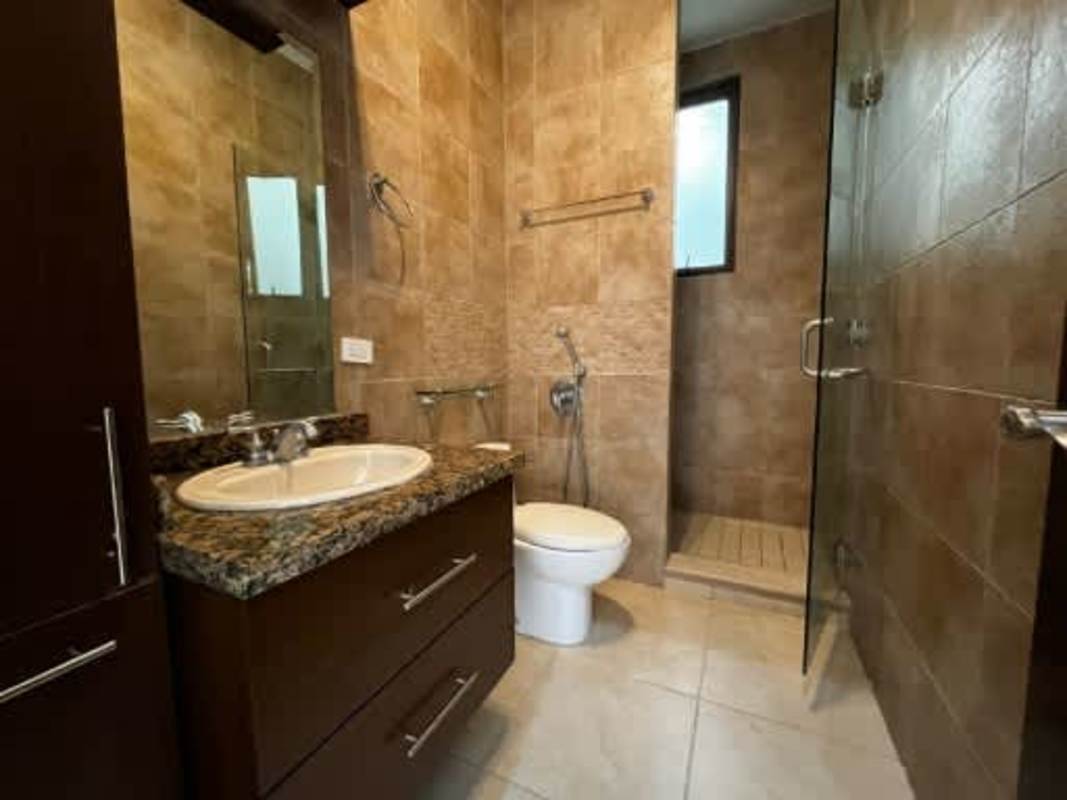 Bathroom with granite countertop, glass shower Embassy Club Clayton Panama home
