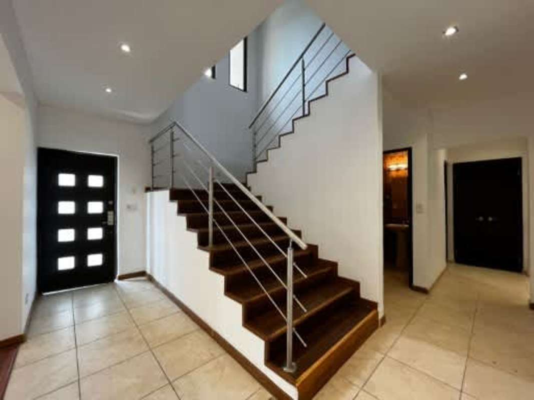 Large modern kitchen with granite counters, stainless appliances in Embassy Club Clayton residence