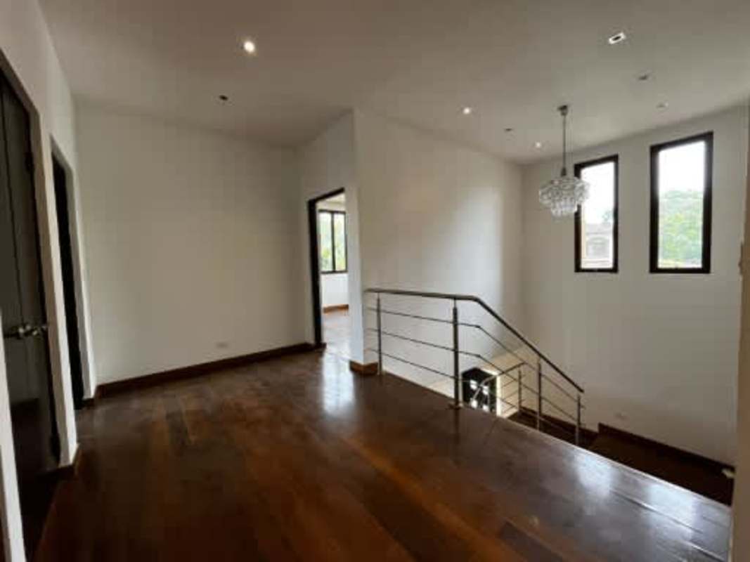 Bedroom with wood floors, sliding glass door, garden view, Embassy Club Clayton