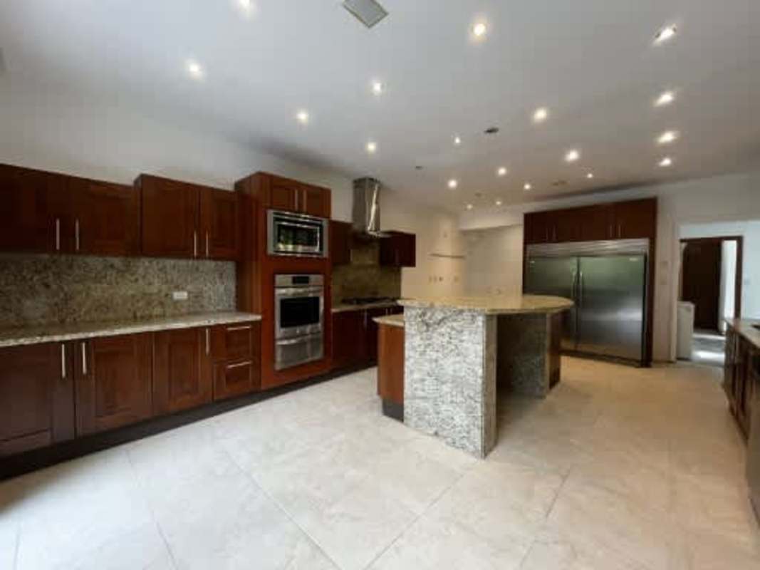 Minimalist hallway with wood floor, large windows, chandelier Embassy Club Panama