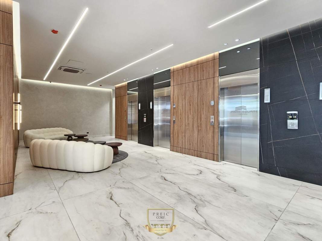 Contemporary lobby with marble floors wood panels elevators PH Park Square Panama