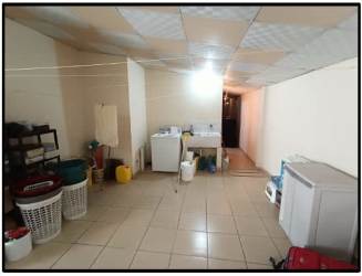 Laundry space with washer, sink, tiled floor in family house Residencial Villa del Carmen Panama