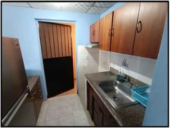 Compact traditional kitchen with granite countertop, wooden cabinets, tiled backsplash in Villa del Carmen house