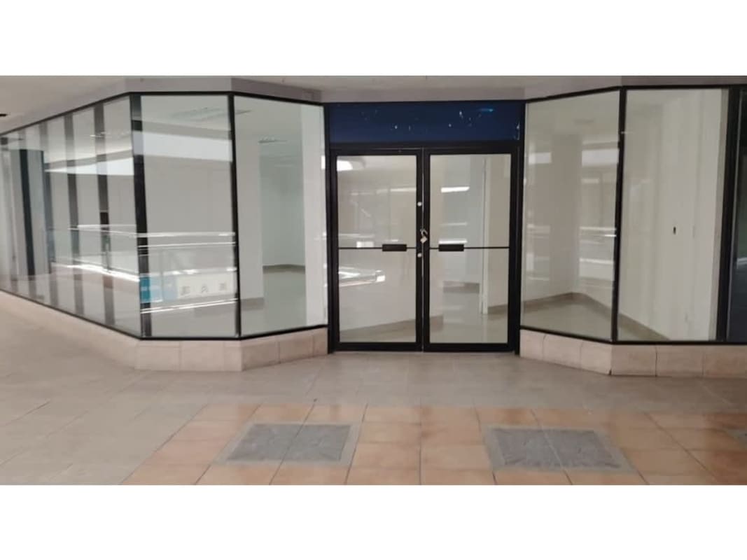 Reflective glass exterior of PH Dorado Mall with parking lot Betania Panama City