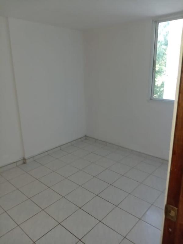 Bedroom with window and white tiles in apartment for sale La Chorrera Panama