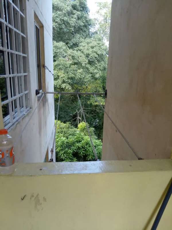 Bathroom with burgundy sink and toilet, shower, yellow walls in apartment La Chorrera Panama