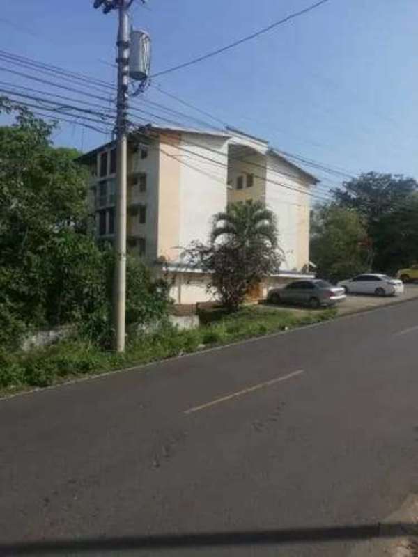 Multi-story residential building with balconies and street view in La Chorrera Panama