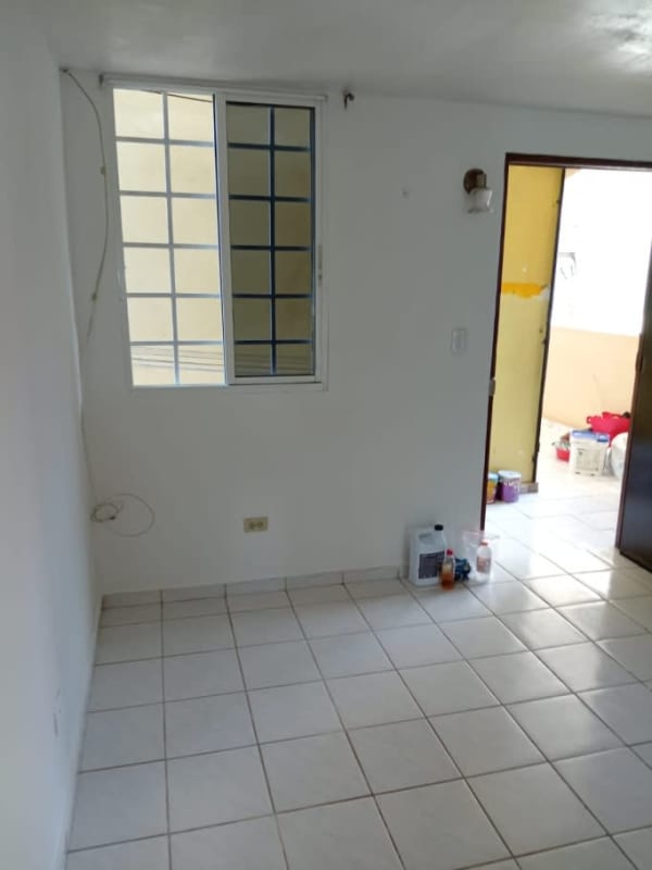 Living room with tiled floor, window, open door to balcony La Chorrera Panama