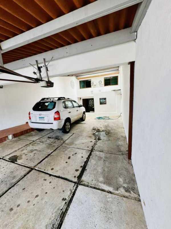 Open living room with double height ceiling, tile flooring and access to patio at house in San Francisco Panama