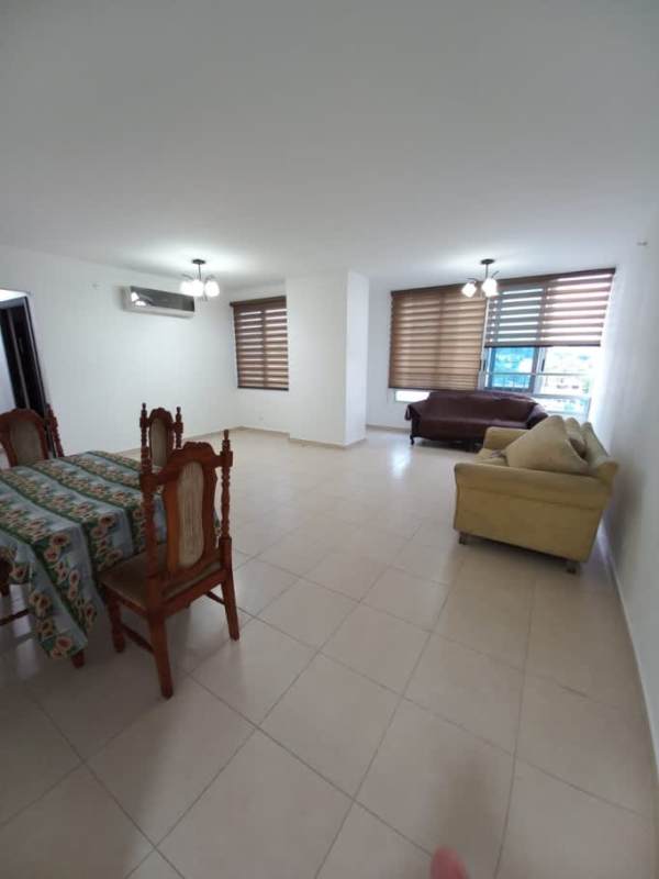 Open-style living and dining room with tile flooring, windows, and AC in Macedonia Towers for sale Panama City