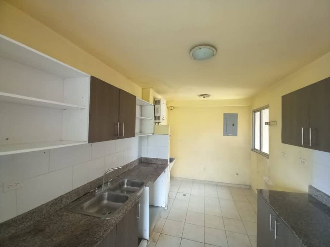 View of swimming pool playground parking and apartment towers at PH Mallorca Park Gardens II San Miguelito