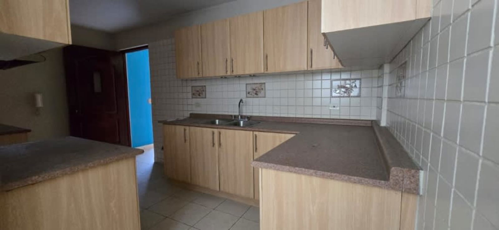 Contemporary kitchen with wood cabinets and backsplash in PH El Carmen Panama