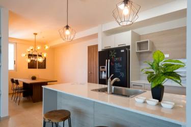 Open dining space with wood table and stylish lighting in Royal Palm Playa Gorgona