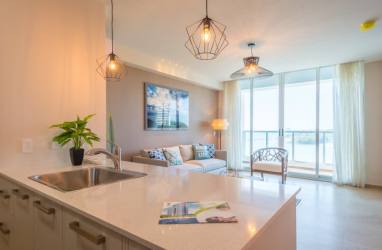 Contemporary living room with sliding glass doors to balcony, ocean views, modern furnishings Playa Gorgona Panama